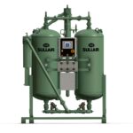 CompressAir | A green Sullair industrial air compressor with two vertical tanks, a control panel in the center, and various pipes and connections.